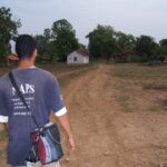 Gavin walking to a village in India.