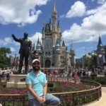 Gavin is in front of the castle at Magic Kingdom.